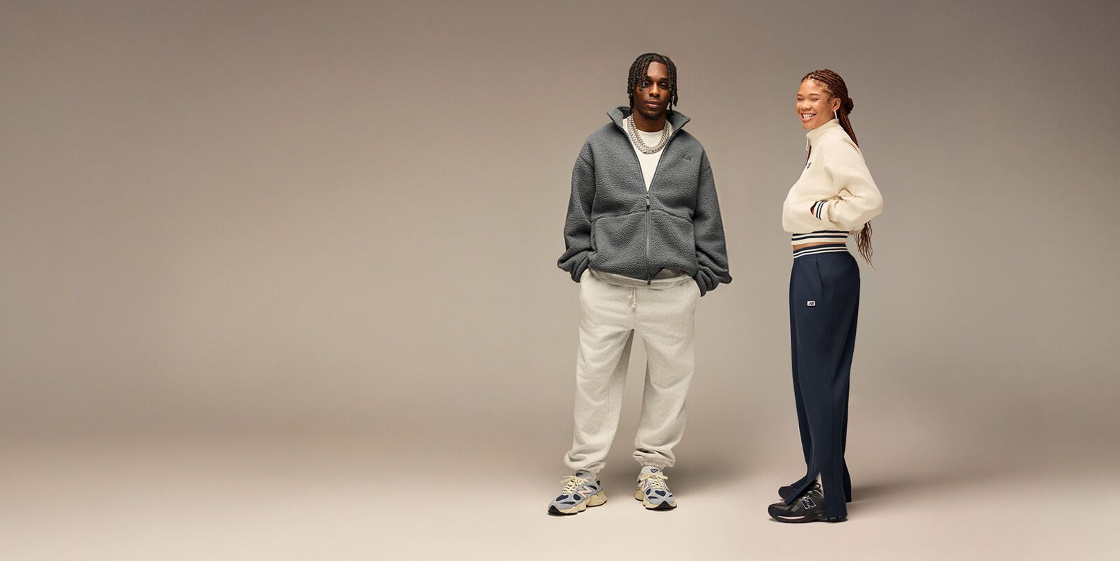 Pile of New Balance sneakers on beige background 
